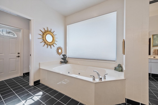 bathroom featuring vanity, a bathtub, and tile patterned floors