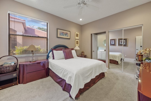 carpeted bedroom featuring ceiling fan and a closet