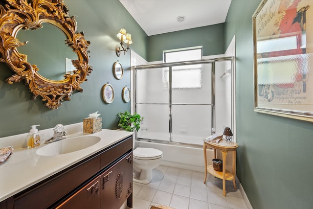 full bathroom featuring tile patterned floors, vanity, bath / shower combo with glass door, and toilet