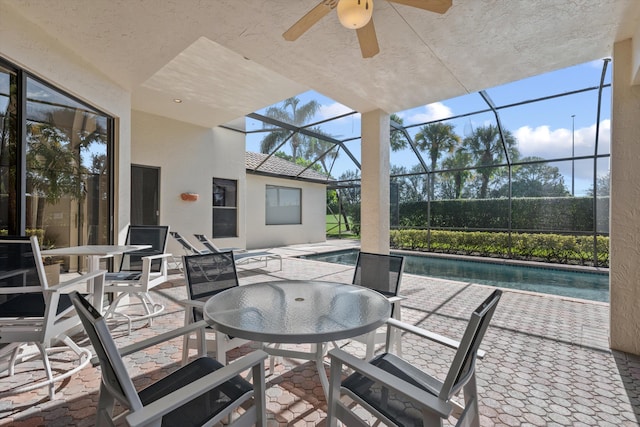 view of patio / terrace with glass enclosure and ceiling fan