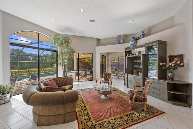 living room featuring light tile patterned flooring and a textured ceiling