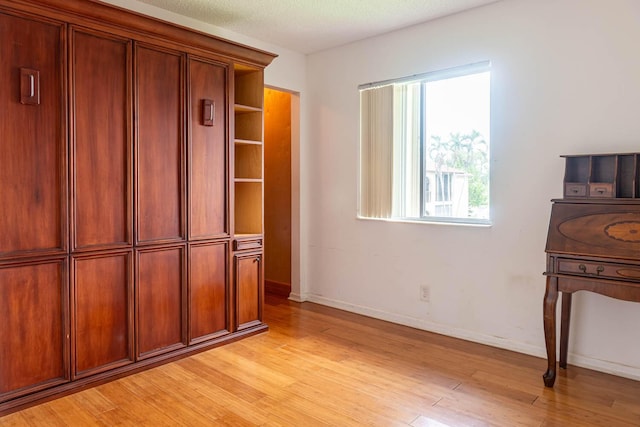 337 Knotty Pine Cir Unit D2, Greenacres, FL 33463 - unfurnished bedroom featuring baseboards and light wood-style flooring