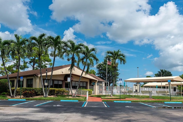 337 Knotty Pine Cir Unit D2, Greenacres, FL 33463 - view of property featuring uncovered parking and fence