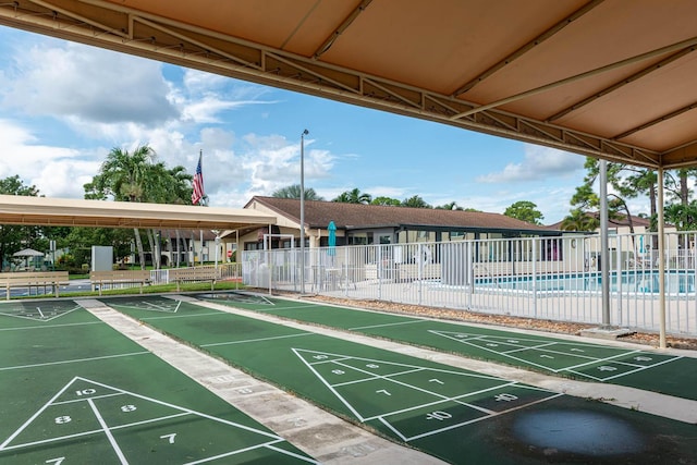 337 Knotty Pine Cir Unit D2, Greenacres, FL 33463 - view of property's community featuring a swimming pool, fence, and shuffleboard