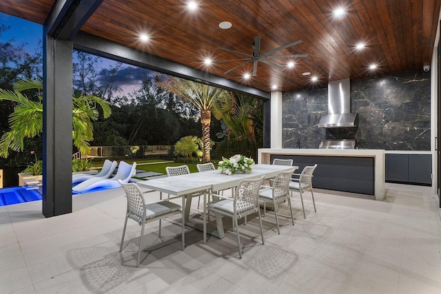 patio terrace at dusk featuring area for grilling, a pool, and ceiling fan