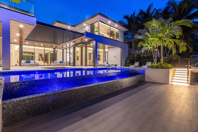 pool at twilight featuring a patio