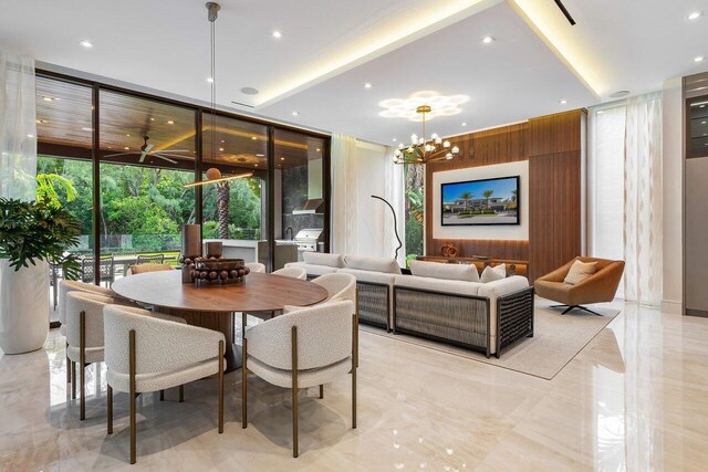 interior space with wood walls, floor to ceiling windows, and a chandelier