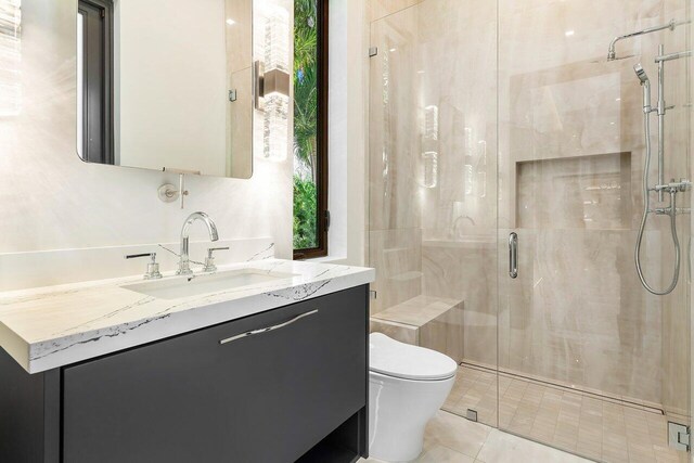 bathroom with walk in shower, tile patterned flooring, vanity, and toilet