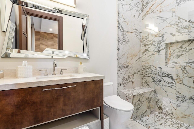 bathroom with vanity, an enclosed shower, and toilet