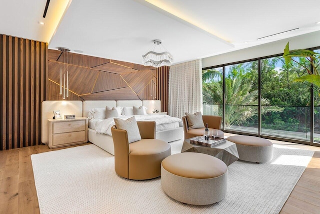 bedroom featuring a notable chandelier and wood-type flooring