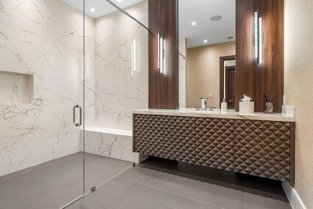 bathroom featuring walk in shower, vanity, and tile patterned floors