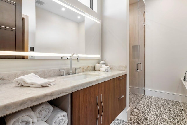 bathroom featuring walk in shower, tile patterned flooring, and vanity