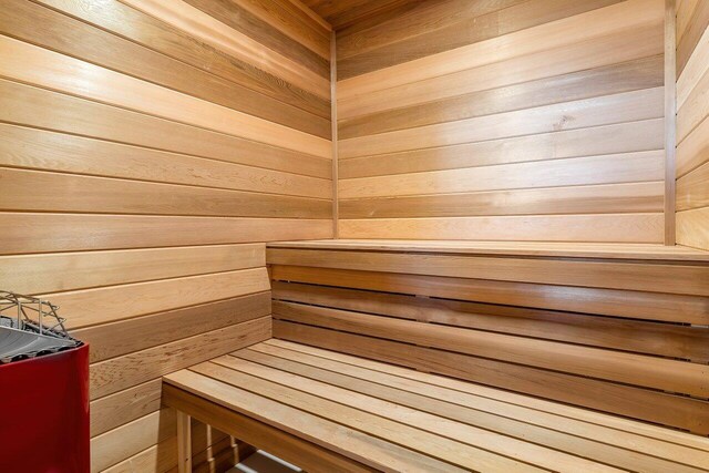 view of sauna / steam room featuring wooden walls