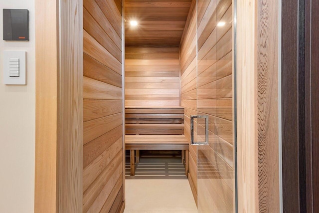 view of sauna featuring wood walls and wooden ceiling