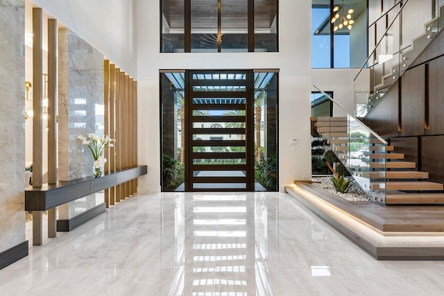 foyer featuring a high ceiling and a wealth of natural light