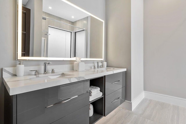 bathroom with vanity and tiled shower