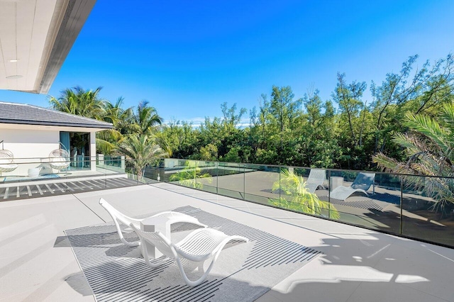 view of patio featuring a balcony