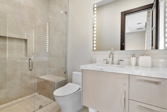 bathroom featuring vanity, a shower with shower door, toilet, and tile patterned floors