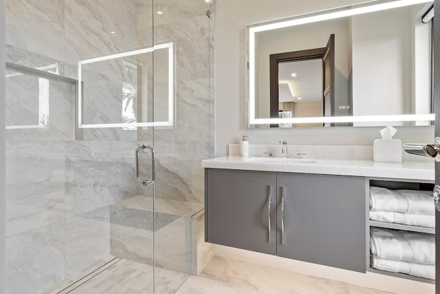 bathroom featuring walk in shower and vanity