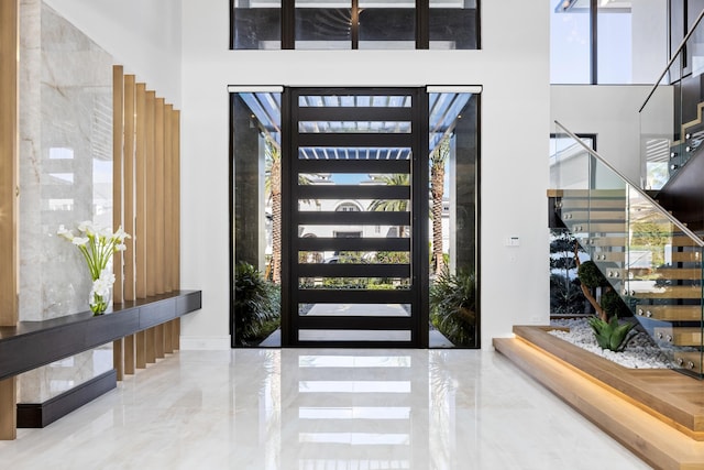 foyer featuring a towering ceiling