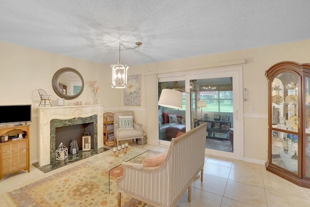 tiled living room featuring a notable chandelier, a high end fireplace, and a textured ceiling