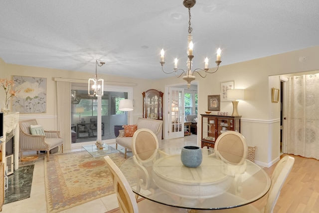 dining space featuring light wood-type flooring and an inviting chandelier