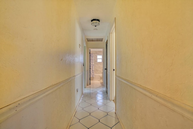 corridor featuring light tile patterned flooring