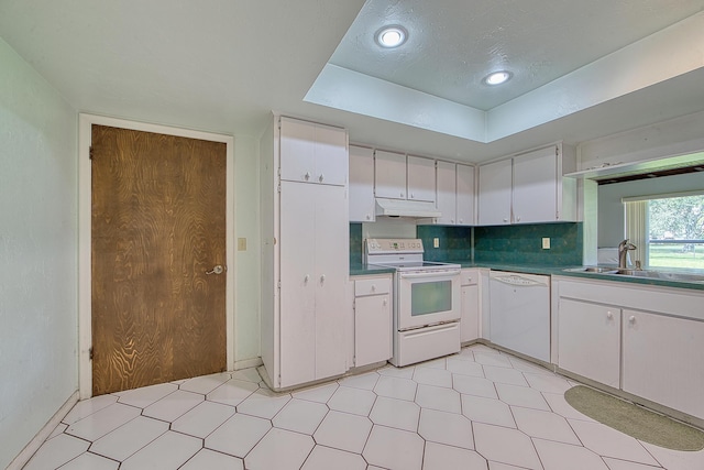 kitchen featuring tasteful backsplash, white cabinetry, sink, and white appliances