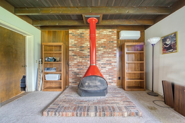 interior space with a wall mounted air conditioner, a wood stove, carpet flooring, beamed ceiling, and wood ceiling