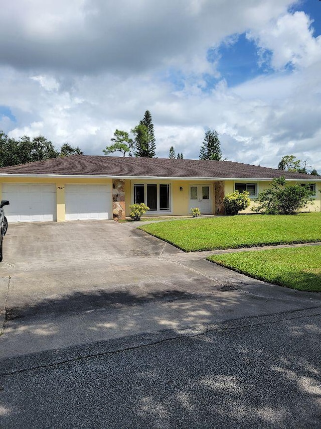 ranch-style house with a front lawn and a garage