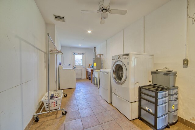 washroom with light tile patterned floors, ceiling fan, and washing machine and clothes dryer