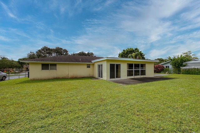 back of house with a lawn