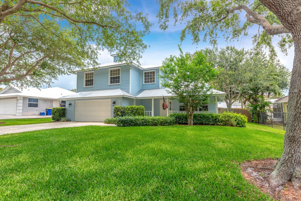 view of front of property with a front yard and a garage