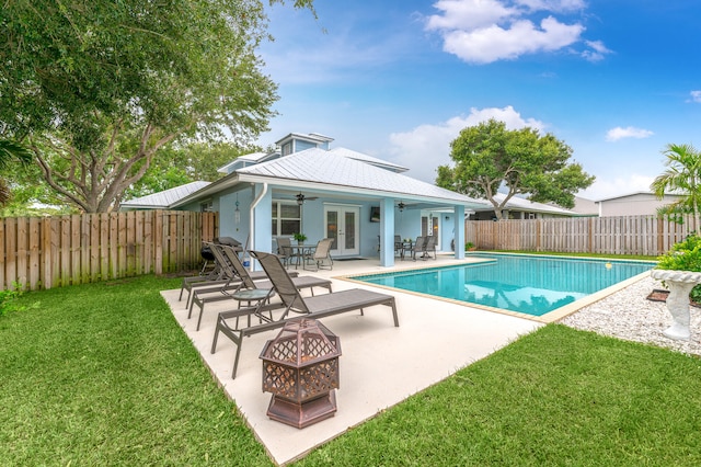 view of pool with ceiling fan, a yard, and a patio