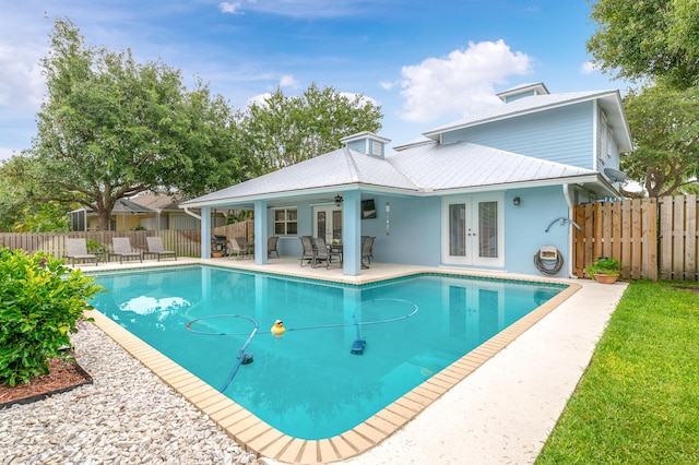 view of pool featuring french doors and a patio