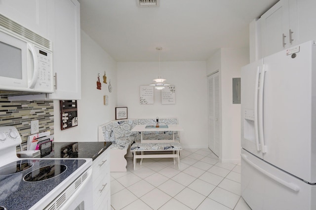 kitchen featuring light tile patterned flooring, white cabinetry, pendant lighting, white appliances, and decorative backsplash