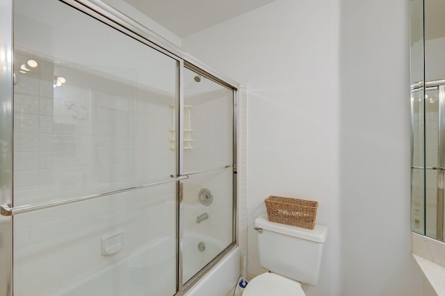 bathroom with bath / shower combo with glass door and toilet