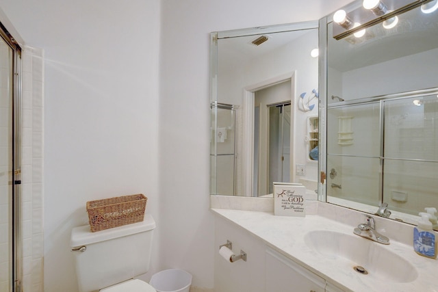 bathroom featuring walk in shower, vanity, and toilet