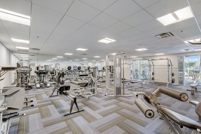 workout area with light colored carpet and a drop ceiling