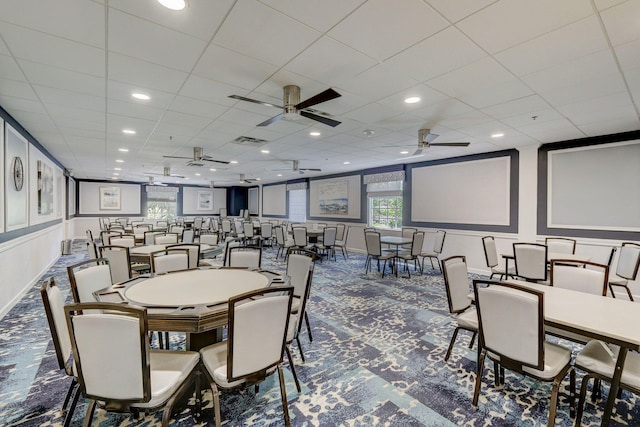 carpeted dining area featuring a drop ceiling