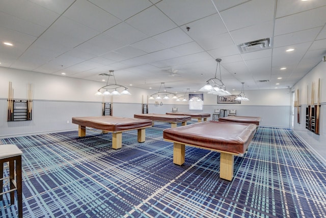 game room featuring pool table, a drop ceiling, and dark colored carpet