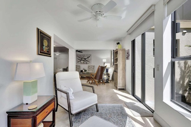 sitting room featuring ceiling fan and a wealth of natural light