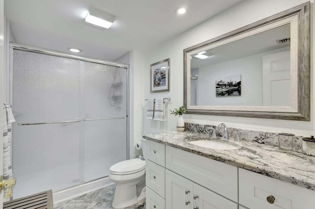 bathroom with walk in shower, vanity, and toilet