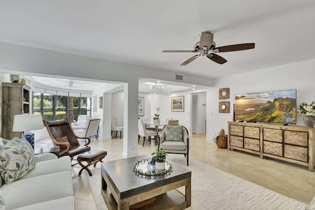 living room featuring ceiling fan and light tile patterned floors