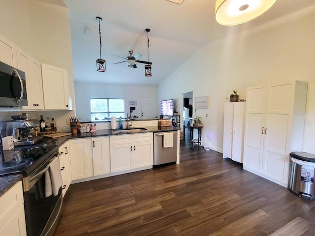 kitchen featuring appliances with stainless steel finishes, hanging light fixtures, white cabinets, and dark hardwood / wood-style flooring