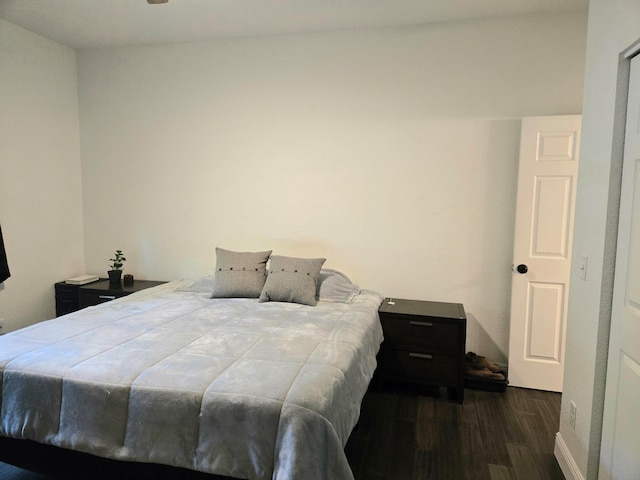 bedroom with dark hardwood / wood-style flooring