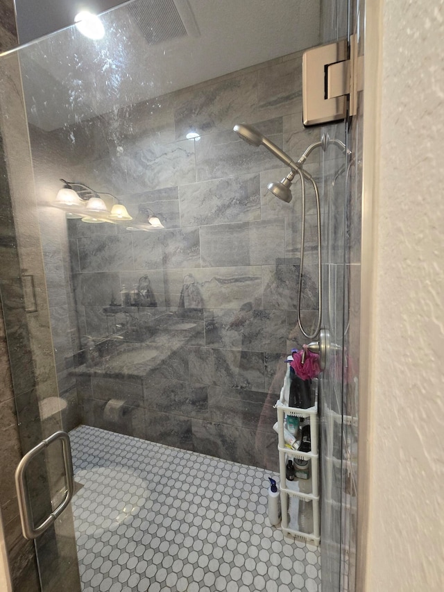 bathroom featuring a shower with shower door