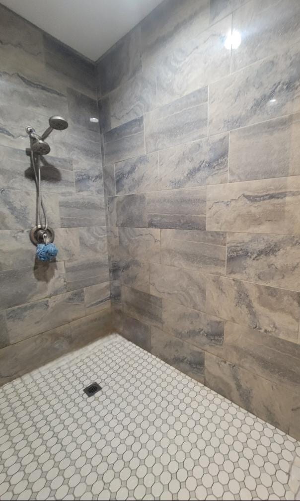 bathroom with tiled shower