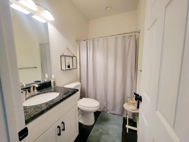 bathroom with vanity, toilet, and a shower with shower curtain