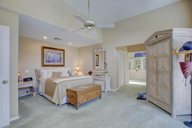 carpeted bedroom featuring ensuite bathroom, high vaulted ceiling, and ceiling fan